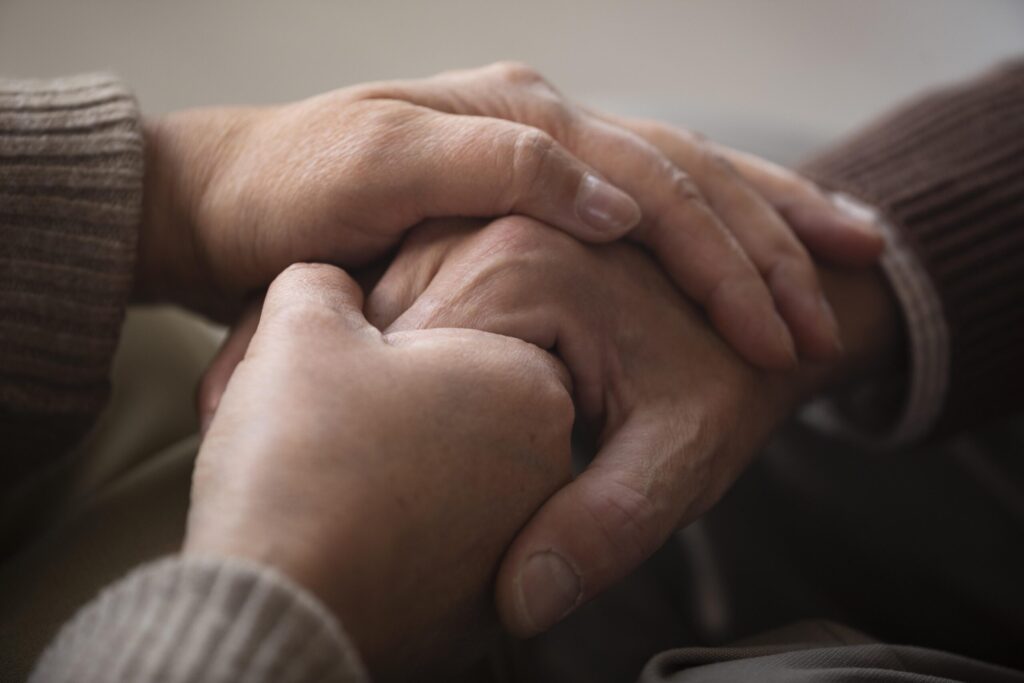 nurse-holding-senior-hand-home-care