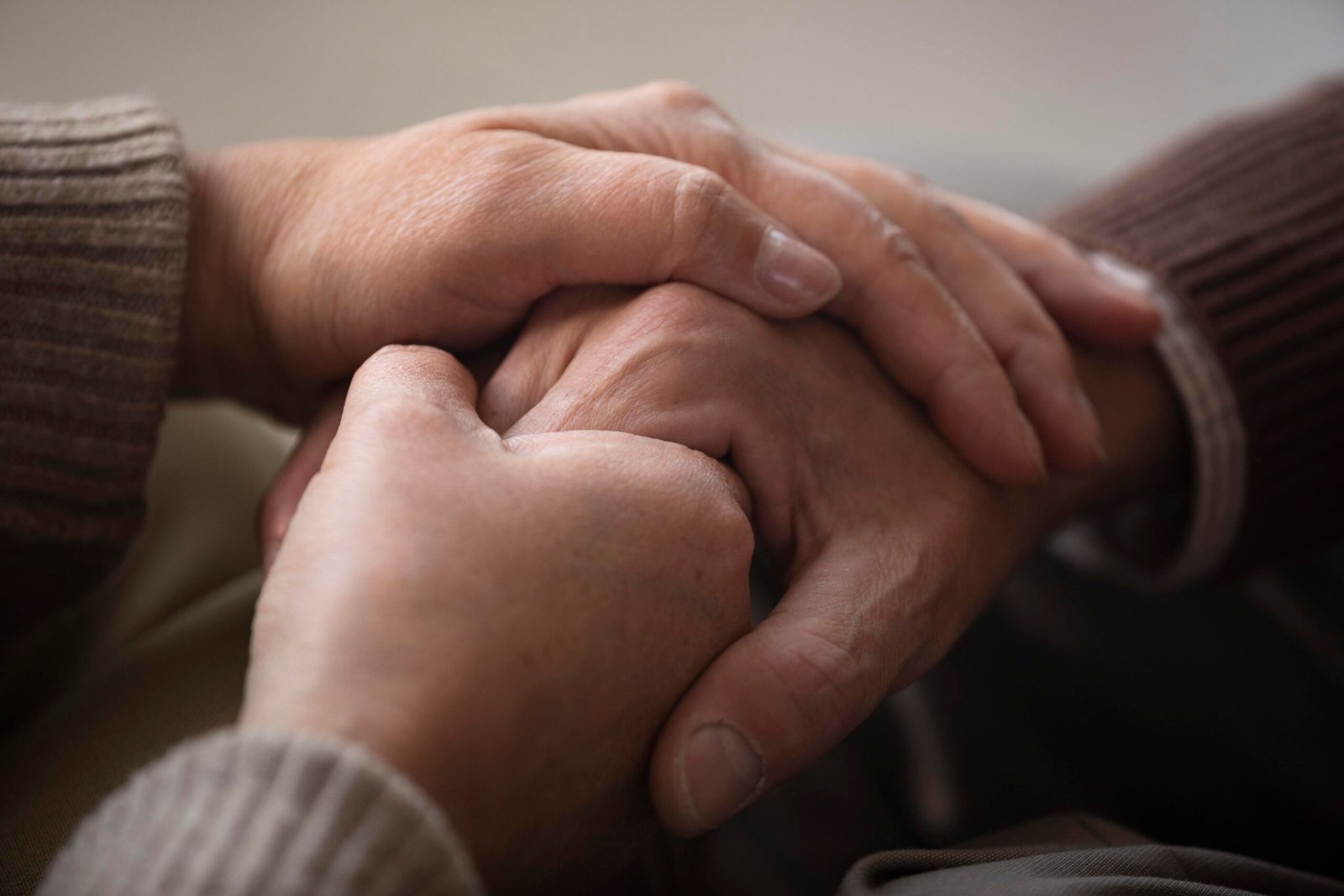 nurse holding senior hand