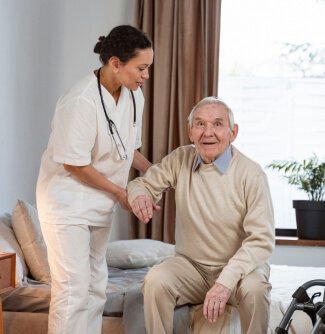 nurse assisting senior man