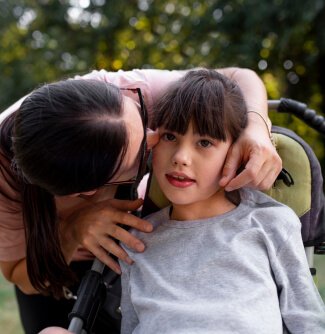 A woman showing love to a little girl